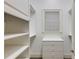 Well-organized walk-in closet with built-in shelving, drawers, and a window for natural light at 314 Caruso Ct, Sandy Springs, GA 30350