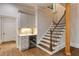 Stylish wet bar area located near the stairs with custom cabinets and a wine refrigerator for the homeowner at 314 Caruso Ct, Sandy Springs, GA 30350