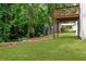 Expansive backyard with mature trees, green lawn, and wooden deck for serene outdoor enjoyment and relaxation at 347 Chip Rd, Stone Mountain, GA 30087