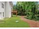 Green backyard with a wood deck and lush trees that creates a tranquil and private outdoor space at 347 Chip Rd, Stone Mountain, GA 30087