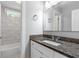Bathroom features a granite countertop vanity with white cabinets and tub with white subway tile at 347 Chip Rd, Stone Mountain, GA 30087