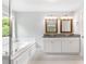 Bathroom featuring double vanity, granite countertops, and a soaking tub at 347 Chip Rd, Stone Mountain, GA 30087