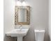 Powder room with pedestal sink and stylish mirror at 347 Chip Rd, Stone Mountain, GA 30087