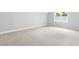 Large bedroom with light gray carpet, neutral walls, and bright window at 347 Chip Rd, Stone Mountain, GA 30087