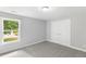 Bedroom with plush carpet, a window, and double door closet at 347 Chip Rd, Stone Mountain, GA 30087