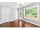Bedroom features hardwood floors, natural light, and a door that leads to a wooden deck at 347 Chip Rd, Stone Mountain, GA 30087