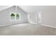 Large bedroom with vaulted ceiling, neutral walls, and gray carpet at 347 Chip Rd, Stone Mountain, GA 30087