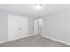 Bedroom with neutral walls, gray carpet, and white doors for closet and entry at 347 Chip Rd, Stone Mountain, GA 30087