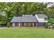 Charming home featuring a modern design with a covered porch and a well-manicured front yard at 347 Chip Rd, Stone Mountain, GA 30087