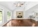 Bright living area with hardwood floors, fireplace feature, and abundant natural light from large windows at 347 Chip Rd, Stone Mountain, GA 30087
