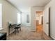 Bedroom with neutral walls, carpet floors, window, and open doorway to the hallway at 4700 Blake Loop, Atlanta, GA 30349