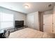 Bedroom featuring neutral walls, carpet, window, and a large television on a table at 4700 Blake Loop, Atlanta, GA 30349