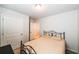Neutral bedroom with carpeted floors, featuring two doors and a wrought iron bed at 4700 Blake Loop, Atlanta, GA 30349