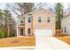 Charming two-story brick home featuring a two-car garage and a well-manicured front yard at 4700 Blake Loop, Atlanta, GA 30349