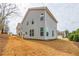 Back exterior of home with neutral siding and large windows providing ample natural light at 4700 Blake Loop, Atlanta, GA 30349