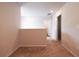 Upstairs hallway with neutral carpeting and paint, featuring a small railing at 4700 Blake Loop, Atlanta, GA 30349
