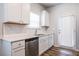 Kitchen features stainless steel appliances, white cabinets, hardwood floors, and quartz countertops at 4700 Blake Loop, Atlanta, GA 30349