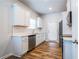 Kitchen with stainless steel appliances, white cabinets, modern fixtures, and hardwood floors at 4700 Blake Loop, Atlanta, GA 30349