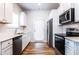 Kitchen with stainless steel appliances, white cabinets, modern fixtures, and hardwood floors at 4700 Blake Loop, Atlanta, GA 30349