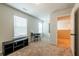 Living room featuring a window, door, small desk, and black tv stand at 4700 Blake Loop, Atlanta, GA 30349