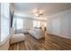 Spacious living room with modern flooring and decor, leading to a bright kitchen with stainless appliances at 4700 Blake Loop, Atlanta, GA 30349