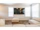 Bright living room featuring modern flooring, large TV, and ample natural light from multiple windows at 4700 Blake Loop, Atlanta, GA 30349