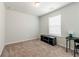 Room featuring neutral walls, window, and tv stand at 4700 Blake Loop, Atlanta, GA 30349