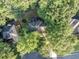 Aerial view showcasing a home nestled among mature trees, featuring a deck or patio and a nearby cul-de-sac at 4817 Overland Dr, Powder Springs, GA 30127