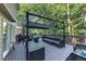 Outdoor back deck featuring an awning, a grill, a table, and wooded backyard views at 4817 Overland Dr, Powder Springs, GA 30127