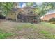 Backyard view with multi-level deck, stairs, shade, lawn and brick siding at 4817 Overland Dr, Powder Springs, GA 30127