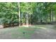 Wide backyard view with storage shed, lawn and plenty of trees at 4817 Overland Dr, Powder Springs, GA 30127