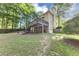 Backyard view with multi-level deck, stairs, shade, lawn and brick siding at 4817 Overland Dr, Powder Springs, GA 30127
