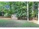Backyard view with storage shed, lawn and shade at 4817 Overland Dr, Powder Springs, GA 30127