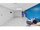 Spacious unfinished basement has bright lighting, gray floors, and a blue accent wall at 4817 Overland Dr, Powder Springs, GA 30127