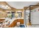 Bright bathroom features a large shower, double sinks atop wood cabinets, and a stool at 4817 Overland Dr, Powder Springs, GA 30127