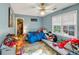 room with blue walls, carpet flooring, a fan, and many toys at 4817 Overland Dr, Powder Springs, GA 30127