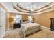 Spacious bedroom features a unique tray ceiling, a ceiling fan, bedside tables and lamps, and plush carpeting at 4817 Overland Dr, Powder Springs, GA 30127