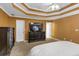 Spacious bedroom features a large dresser, a TV atop a console, a ceiling fan, and plush carpeting at 4817 Overland Dr, Powder Springs, GA 30127