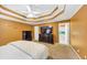 Spacious bedroom features a unique tray ceiling, a ceiling fan, and plush carpeting at 4817 Overland Dr, Powder Springs, GA 30127