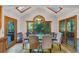 Bright dining room with hardwood floors, skylights, and views of the lush backyard at 4817 Overland Dr, Powder Springs, GA 30127