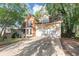 A two-story brick and siding home with a front porch and two car garage and long driveway at 4817 Overland Dr, Powder Springs, GA 30127