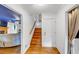 Bright entryway with hardwood floors, staircase, and doorway to a cozy living area with fireplace at 4817 Overland Dr, Powder Springs, GA 30127