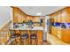 Open kitchen layout with breakfast bar, wooden cabinetry, tile backsplash, and modern appliances, creating a functional space at 4817 Overland Dr, Powder Springs, GA 30127