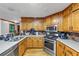 Well-lit kitchen with stainless steel appliances, plenty of cabinet space, and tiled backsplash at 4817 Overland Dr, Powder Springs, GA 30127