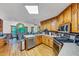 Well-lit kitchen featuring modern stainless steel appliances, wood cabinets and open view of a separate dining area at 4817 Overland Dr, Powder Springs, GA 30127