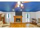 Cozy living room featuring a fireplace, hardwood floors, and large windows that provide natural light at 4817 Overland Dr, Powder Springs, GA 30127