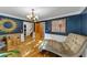 Stylish living room with hardwood floors, decorative mirror and paintings with a comfortable chase lounge at 4817 Overland Dr, Powder Springs, GA 30127