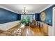 Cozy living room with hardwood floors, a bay window, and a comfortable seating area with stylish furniture at 4817 Overland Dr, Powder Springs, GA 30127