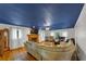 Spacious living room featuring a fireplace, hardwood floors, and a dark blue painted ceiling at 4817 Overland Dr, Powder Springs, GA 30127