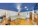 Spacious living room featuring hardwood floors, fireplace, and modern leather sofa with a pop of color from the blue painted ceiling at 4817 Overland Dr, Powder Springs, GA 30127